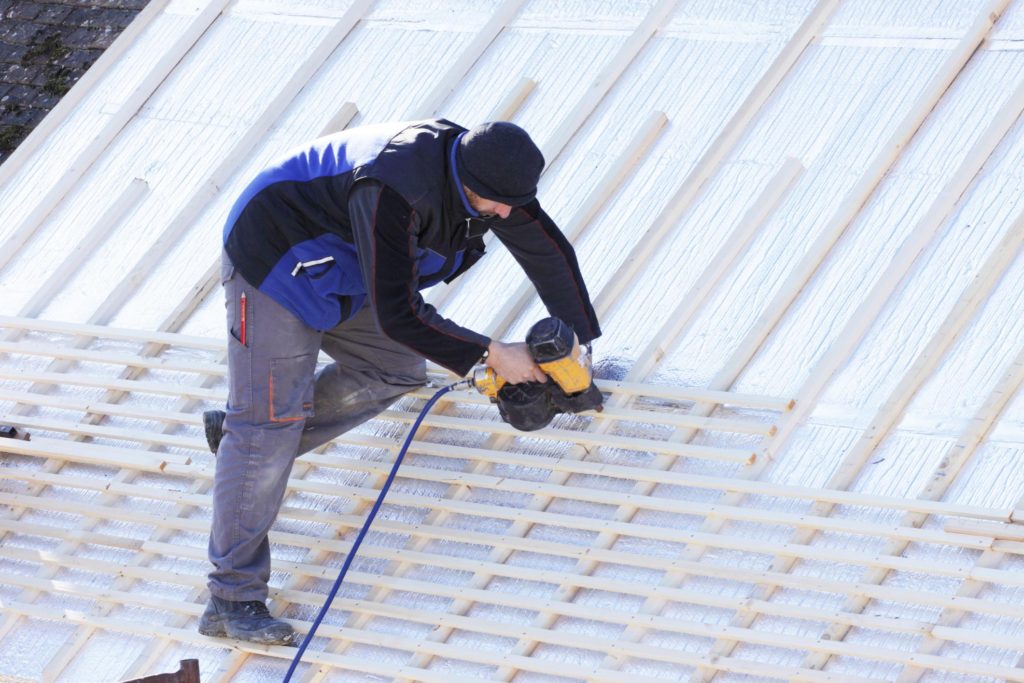 man drilling the roof