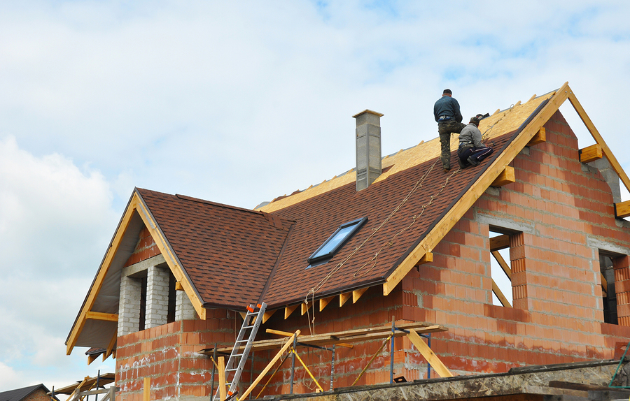 two repairman on the roof