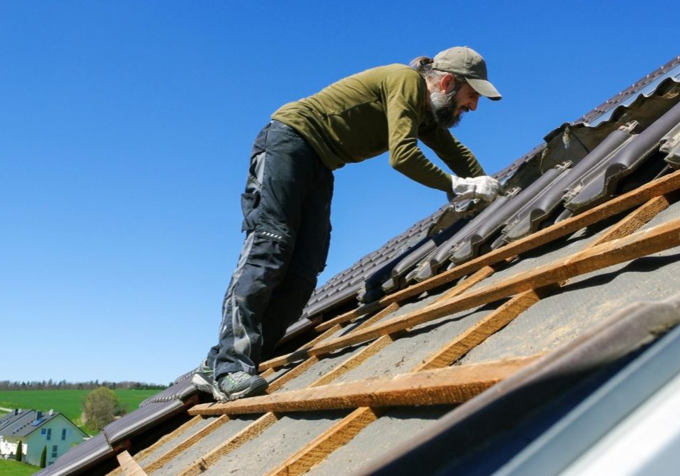 man installing shingle in the roof